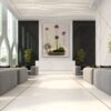 A large white lobby with plants and flowers.