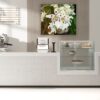 A white counter top with some flowers on it